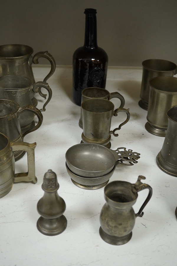 A collection of 18th and 19th century pewter mugs and other items including a 19th century wine bottle, bottle 27cm high. Condition - fair